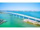 Expansive bridge spanning turquoise waters with distant city views, surrounded by lush landscape at 12607 San Blas Loop, Largo, FL 33774