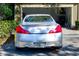 Close-up rear view of a silver Infiniti G37S parked in front of a garage at 12607 San Blas Loop, Largo, FL 33774