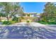 Exterior view of townhome with garages and lush landscaping at 12607 San Blas Loop, Largo, FL 33774