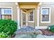 Elegant front entrance featuring glass door and brick pathway at 12607 San Blas Loop, Largo, FL 33774