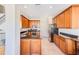 Well-lit kitchen featuring stainless steel appliances, granite counters, and wood cabinets at 12607 San Blas Loop, Largo, FL 33774