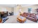 Upstairs Living Room with neutral carpet, leather sofa, desk, and ceiling fan at 12607 San Blas Loop, Largo, FL 33774