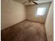 Bedroom featuring a ceiling fan, one window, and worn carpet at 1302 Highview Rd, Brandon, FL 33510