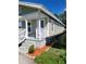 Side view of a single-story house with white trim, light siding and simple landscaping at 1321 W North B St, Tampa, FL 33606