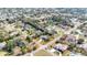 Aerial view of home in a residential neighborhood with mature trees and lush landscaping at 13855 Rudi Loop, Spring Hill, FL 34609