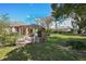 Backyard view featuring patio, yard, and screened pool area perfect for entertaining or relaxation at 13855 Rudi Loop, Spring Hill, FL 34609