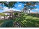 Backyard view featuring patio, yard, and screened pool area perfect for entertaining or relaxation at 13855 Rudi Loop, Spring Hill, FL 34609