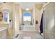 Elegant bathroom featuring a soaking tub and natural light from a window at 13855 Rudi Loop, Spring Hill, FL 34609