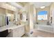 Well-lit bathroom with a soaking tub and vanity area at 13855 Rudi Loop, Spring Hill, FL 34609