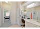 Bathroom vanity and chair between main bedroom and shower at 13855 Rudi Loop, Spring Hill, FL 34609