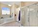 Bathroom showcasing a soaking tub and glass-enclosed shower at 13855 Rudi Loop, Spring Hill, FL 34609