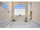 Soaking tub with window in neutral bathroom at 13855 Rudi Loop, Spring Hill, FL 34609