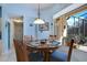 Cozy breakfast nook featuring round table with seating for four and a window with a view of the pool at 13855 Rudi Loop, Spring Hill, FL 34609