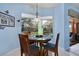 Sunlit breakfast nook with circular table and charming view of the pool and outdoor living area at 13855 Rudi Loop, Spring Hill, FL 34609