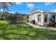 Exterior shot shows the lawn, and screened-in pool, highlighting outdoor living at 13855 Rudi Loop, Spring Hill, FL 34609