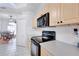 Well-equipped kitchen features stainless steel appliances and light wood cabinets, adjacent to the breakfast nook at 13855 Rudi Loop, Spring Hill, FL 34609