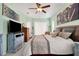 Light and bright main bedroom suite featuring a ceiling fan and decor at 13855 Rudi Loop, Spring Hill, FL 34609