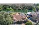 Aerial view of home with pool, lush landscaping and a private waterfront view at 14917 Barby Ave, Tampa, FL 33625