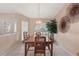 Cozy dining area featuring a wooden table set, pendant lighting, and a large arched window at 14917 Barby Ave, Tampa, FL 33625