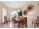 Cozy dining area featuring a wooden table set, pendant lighting, and a large arched window at 14917 Barby Ave, Tampa, FL 33625