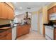 Bright kitchen featuring wood cabinets, granite countertops, tile floor and an open layout at 14917 Barby Ave, Tampa, FL 33625