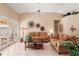 Comfortable living room featuring tile floors, neutral tones, and access to the outdoor living space at 14917 Barby Ave, Tampa, FL 33625