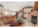 Open living space with views into dining area, featuring a stone fireplace and comfortable seating at 14917 Barby Ave, Tampa, FL 33625