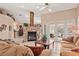 Comfortable living room featuring stone fireplace, tile floors, and French doors to the patio at 14917 Barby Ave, Tampa, FL 33625