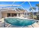 Screened in-ground pool with a view of the home, patio and backyard at 14917 Barby Ave, Tampa, FL 33625