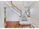 Bright foyer featuring high ceilings, wood and marble flooring, and a staircase with white railings at 15901 Benton Ct, Tampa, FL 33647