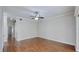 Large living room featuring hardwood floors, neutral paint, and a ceiling fan for added comfort at 15901 Benton Ct, Tampa, FL 33647