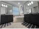 Bright bathroom featuring dual vanities, granite countertops, and a luxurious soaking tub at 17736 Hickok Belt Loop, Bradenton, FL 34211