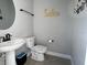 Bathroom featuring a pedestal sink, modern fixtures, and decorative accents at 17736 Hickok Belt Loop, Bradenton, FL 34211