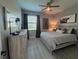 Cozy bedroom with natural light, a wood accent wall, and stylish decor at 17736 Hickok Belt Loop, Bradenton, FL 34211