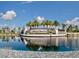 Landscaped community entrance with water feature and clear blue sky at 17736 Hickok Belt Loop, Bradenton, FL 34211