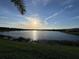 Picturesque lake view at sunset, showcasing the natural beauty surrounding the property at 17736 Hickok Belt Loop, Bradenton, FL 34211