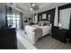 Modern main bedroom with beautiful floors, an accent wall, and balcony access at 17736 Hickok Belt Loop, Bradenton, FL 34211