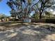 Expansive backyard with a concrete patio and storage shed, enclosed by a wooden privacy fence at 1919 E Noel St, Tampa, FL 33610