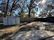 Spacious backyard featuring a storage shed, fire pit, and a wooden fence for added privacy at 1919 E Noel St, Tampa, FL 33610