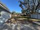 Spacious backyard enclosed by a wooden fence, offering a private area with a concrete patio at 1919 E Noel St, Tampa, FL 33610