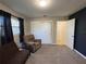 Bedroom with closet, carpeting, a window, and a futon with recliner at 1919 E Noel St, Tampa, FL 33610