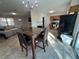 Bright dining area adjacent to kitchen featuring a modern chandelier and a four-seat dining table at 1919 E Noel St, Tampa, FL 33610