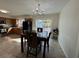 Dining area with modern lighting adjacent to the kitchen and a sliding glass door at 1919 E Noel St, Tampa, FL 33610