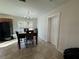 Eat-in dining area featuring tile floors, modern chandelier, and natural light from backyard window at 1919 E Noel St, Tampa, FL 33610