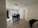 Open-concept dining area with modern chandelier and adjacent to the kitchen at 1919 E Noel St, Tampa, FL 33610