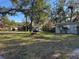 Charming home with manicured front yard, featuring a mature shade tree, a well maintained lawn, and convenient street parking at 1919 E Noel St, Tampa, FL 33610