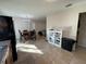 Open concept kitchen and dining area with tile floors and stainless steel refrigerator at 1919 E Noel St, Tampa, FL 33610