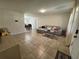 Spacious living room with neutral paint, tile flooring, and comfortable sectional sofa at 1919 E Noel St, Tampa, FL 33610