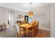 Cozy dining room featuring a wooden table with seating for six and decorative lighting at 2037 Blue River Rd, Holiday, FL 34691