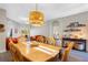 Dining room table with seating for six and decorative lighting, open to the living room at 2037 Blue River Rd, Holiday, FL 34691